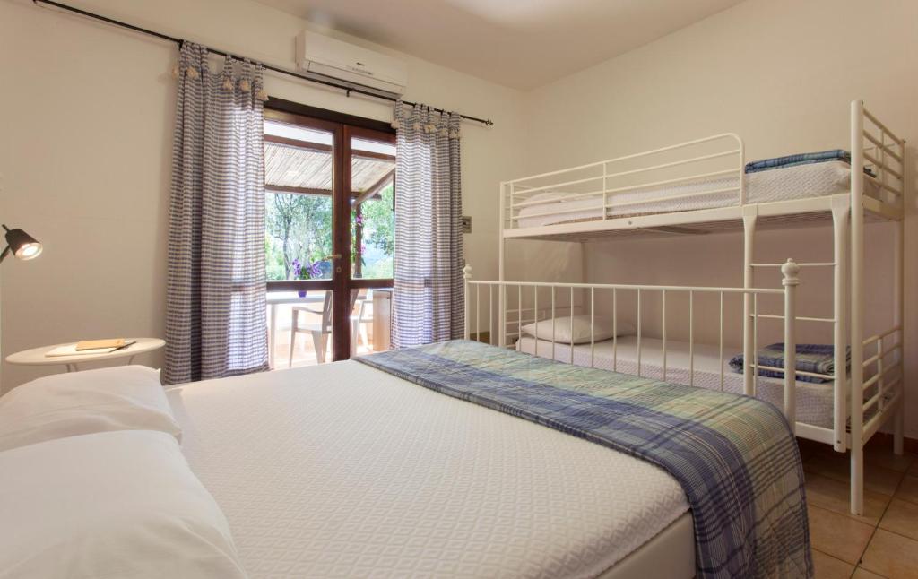 Postel nebo postele na pokoji v ubytování Camping Village Capo D'Orso