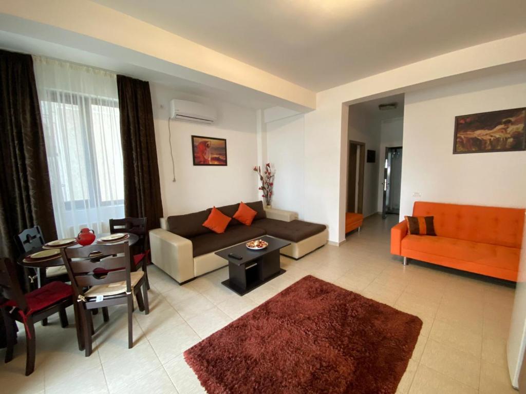 a living room with a couch and a table at Apartament Ella D25 Mackerel in Mamaia Sat/Năvodari