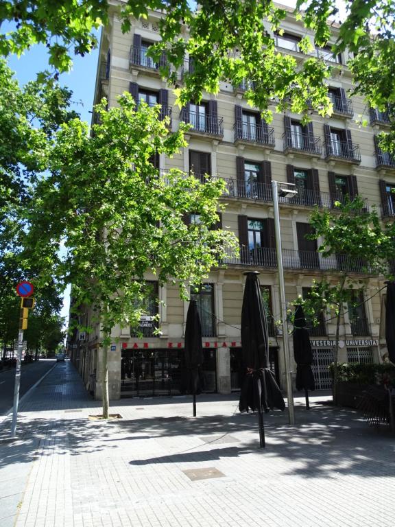 a building with closed umbrellas in front of it at The Hotel 592 - Adults Only in Barcelona