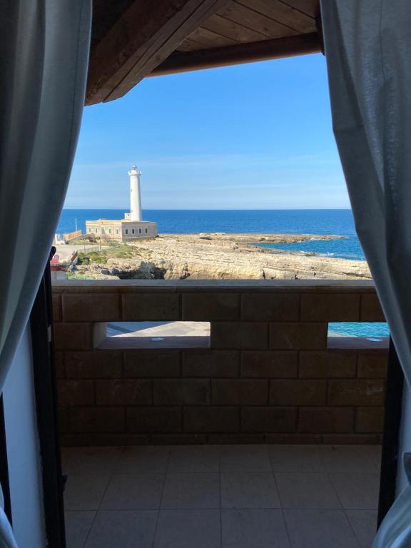 uma vista para um farol a partir de um quarto com uma janela em Sicilian Seaside Apartments em Augusta
