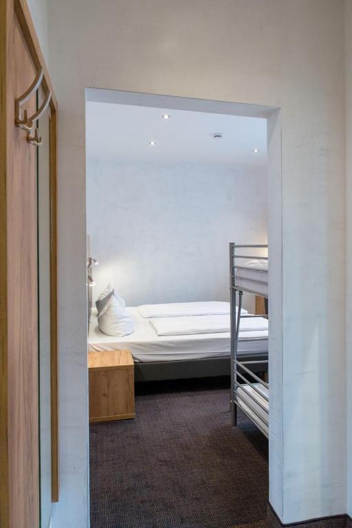 Postel nebo postele na pokoji v ubytování Hotel Fischertor