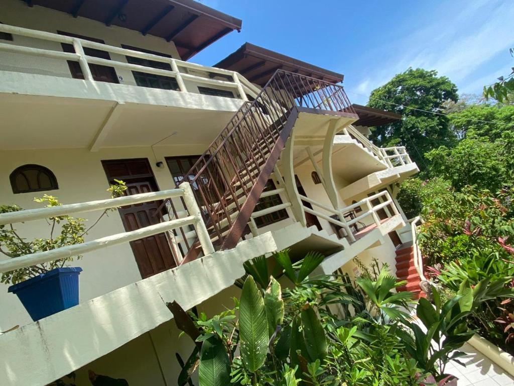 a house with stairs leading up to it at Hotel La Colina in Manuel Antonio
