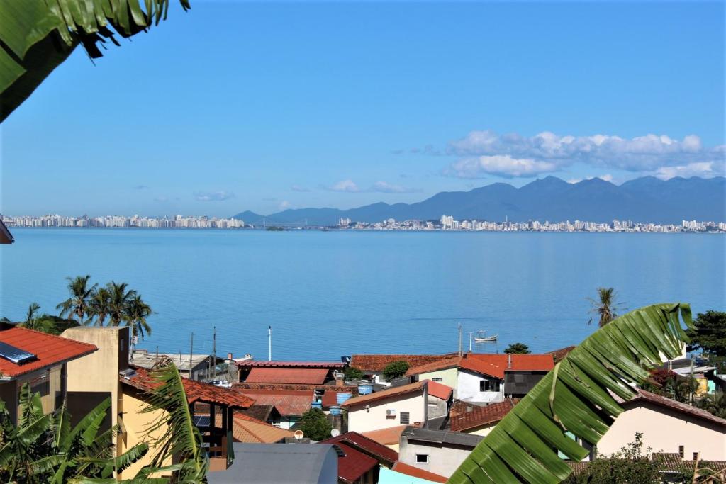 a view of the ocean from a city at Magic Island Casas in Florianópolis