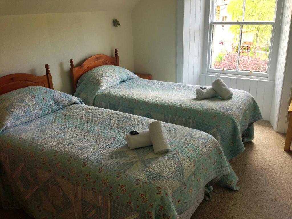 Postel nebo postele na pokoji v ubytování Buttonboss Lodge B&B