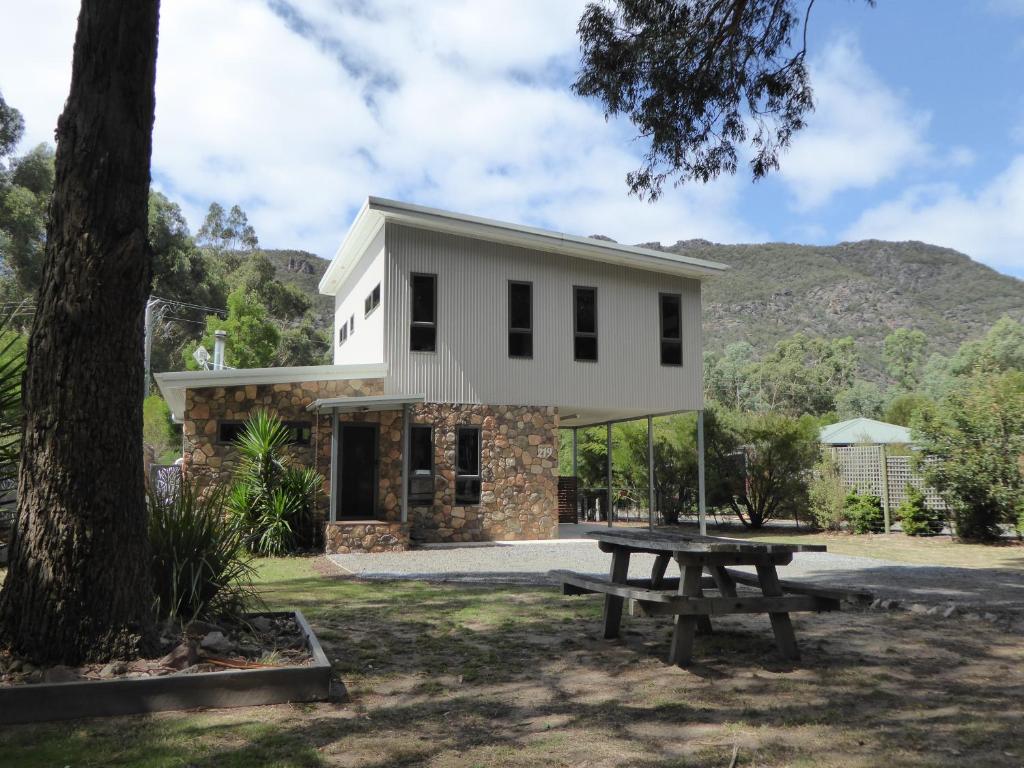 una casa con un tavolo da picnic di fronte di Dacelo a Halls Gap