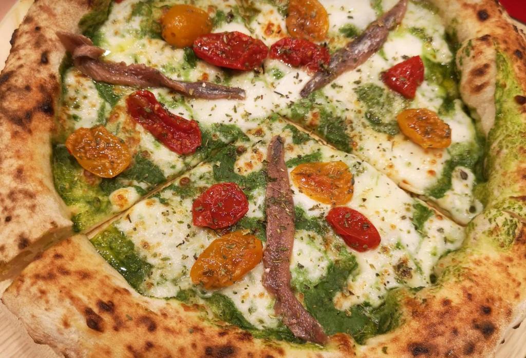a pizza with pepperoni and peppers on a table at Mari del Sud Resort in Vulcano