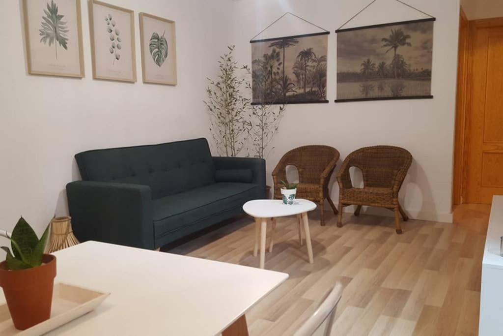 ein Wohnzimmer mit einem Sofa, einem Tisch und Stühlen in der Unterkunft Mirador del Mar in Gran Alacant