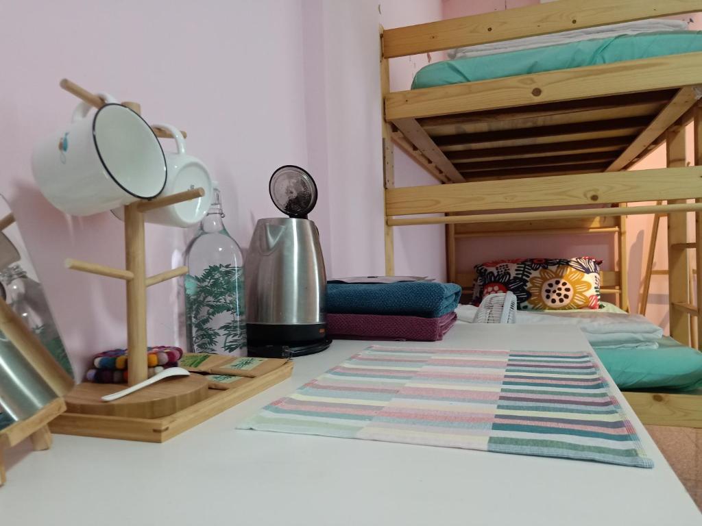 a bedroom with bunk beds and a table with a mirror at Fish Hostel in Yingge