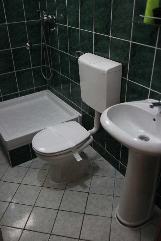 a bathroom with a toilet and a sink at Apartments Vila Monegro in Bar