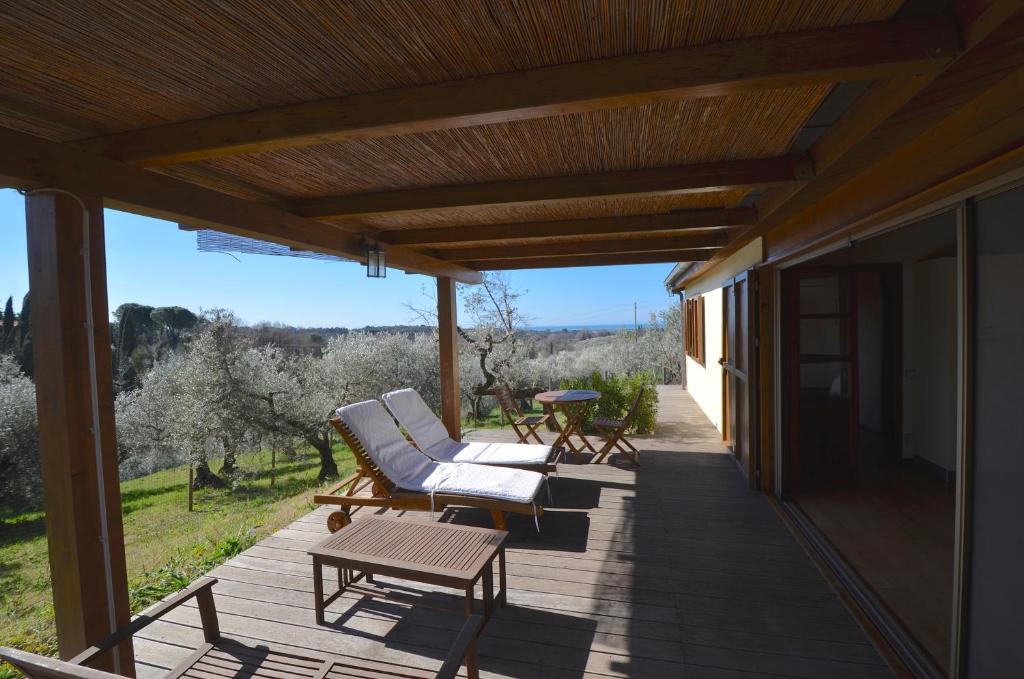 a patio with two chairs and a table on a house at CASE&COLLINE Seaview in Guardistallo