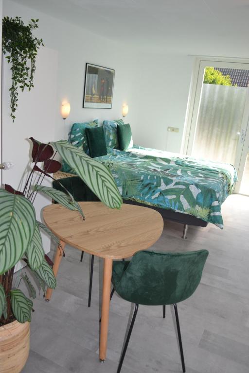 a living room with a bed and two tables at Studio 38 in Zandvoort