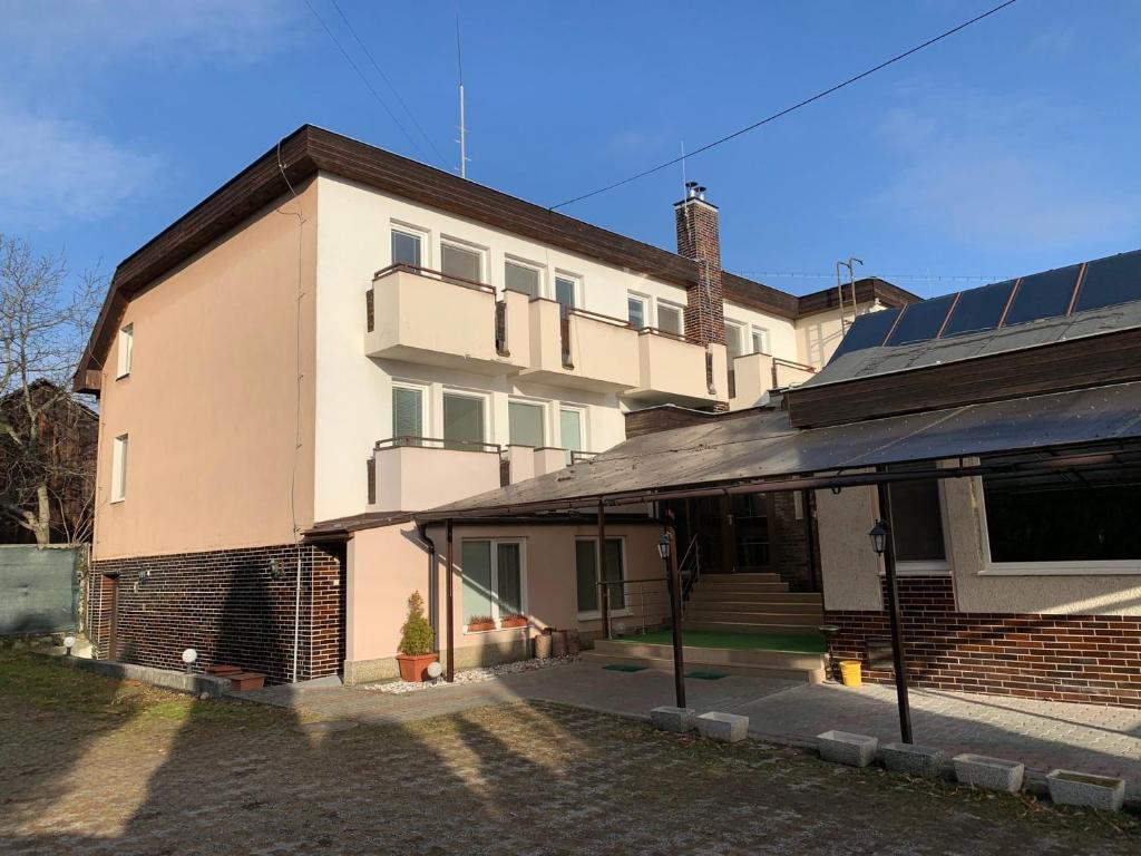 a building with solar panels on the side of it at Penzión MADO I in Bojnice