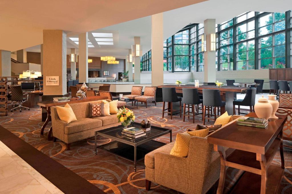 a lobby with couches and tables and a bar at The Stamford Hotel in Stamford