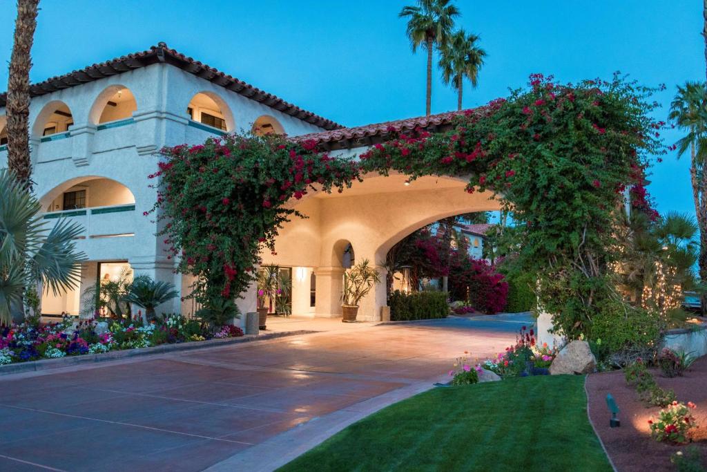 a building with an arch with flowers on it at Best Western Plus Las Brisas Hotel in Palm Springs