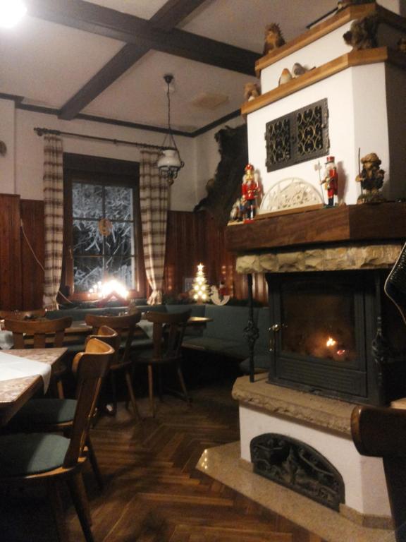 a dining room with a fireplace and a dining table at Turmgaststätte Löbau in Löbau