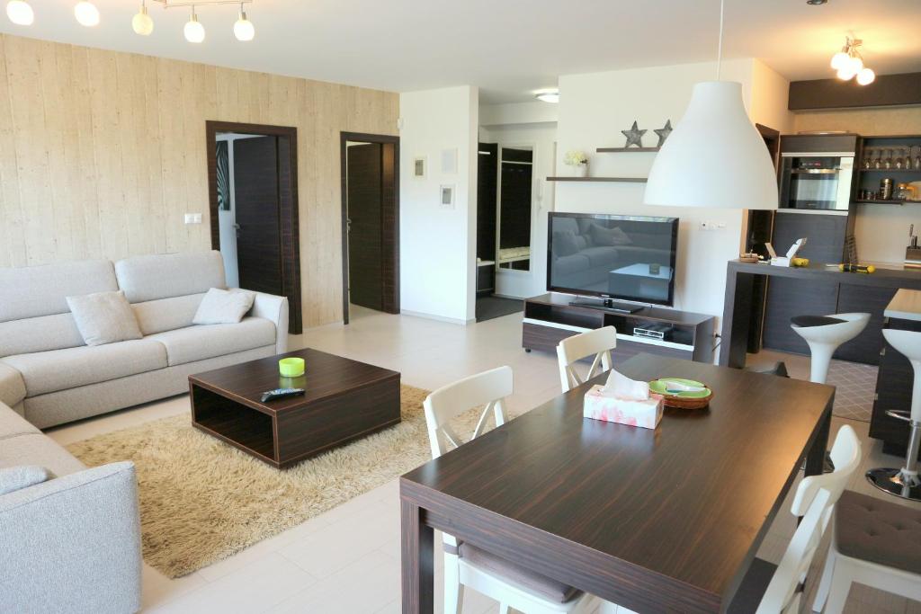 a living room with a couch and a table and a tv at Panorama Donovaly 42-C in Donovaly