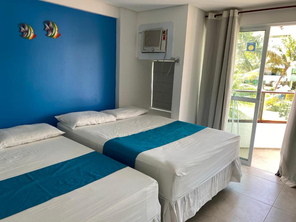 Katil atau katil-katil dalam bilik di Ancorar Flats Condomínio à Beira Mar