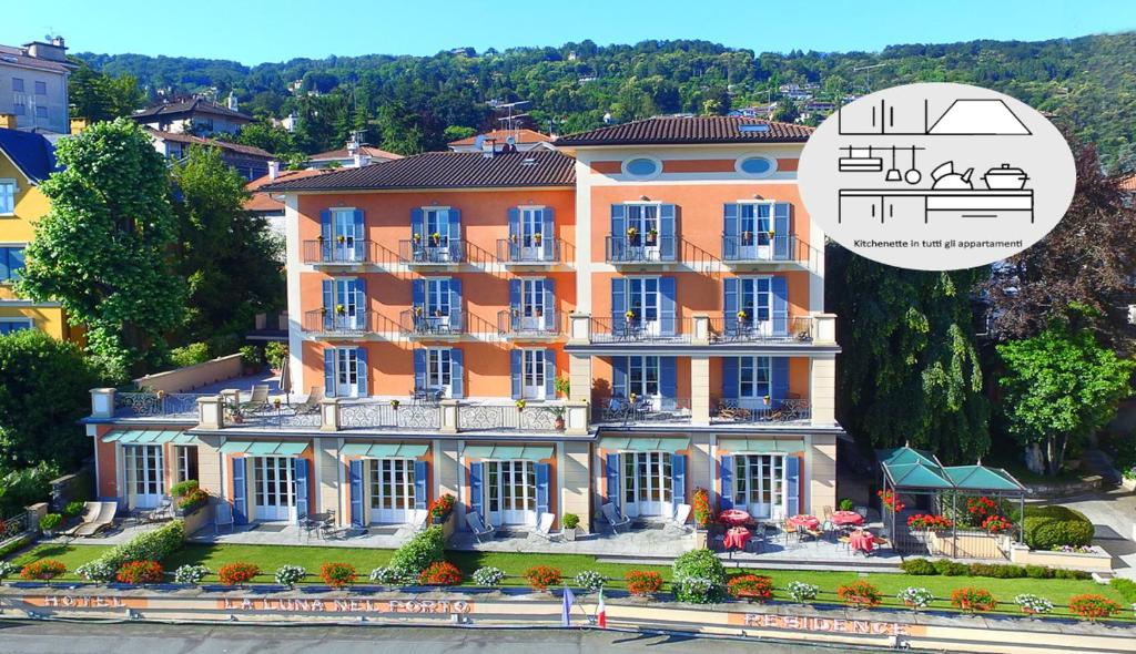 a large orange building with a music overlay at Hotel Residence La Luna Nel Porto in Stresa
