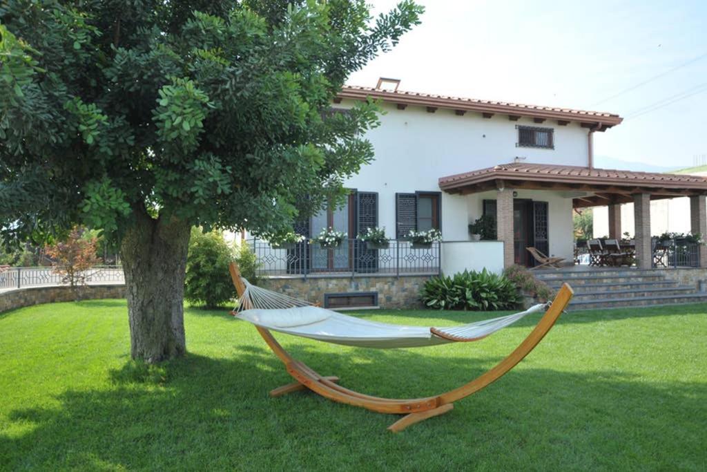 a hammock in a yard in front of a house at APPARTAMENT '' IL GIARDINO '' in Santa Maria La Carità