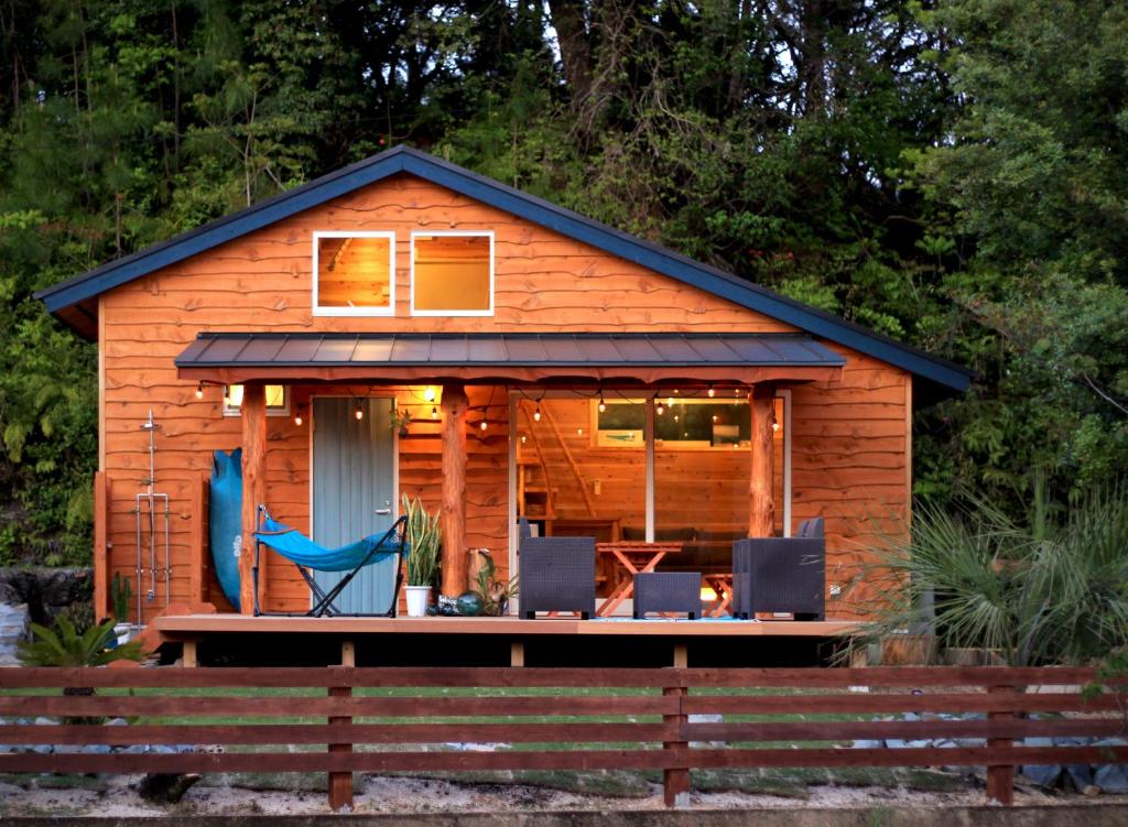 a tiny house with a porch and a deck at PACIFICO SURF HOUSE - Mountain in Shishikui