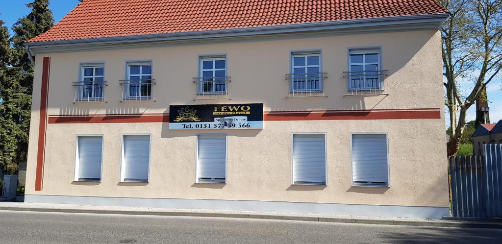 a building with a sign on the side of it at FeWo an der Havel in Zehdenick