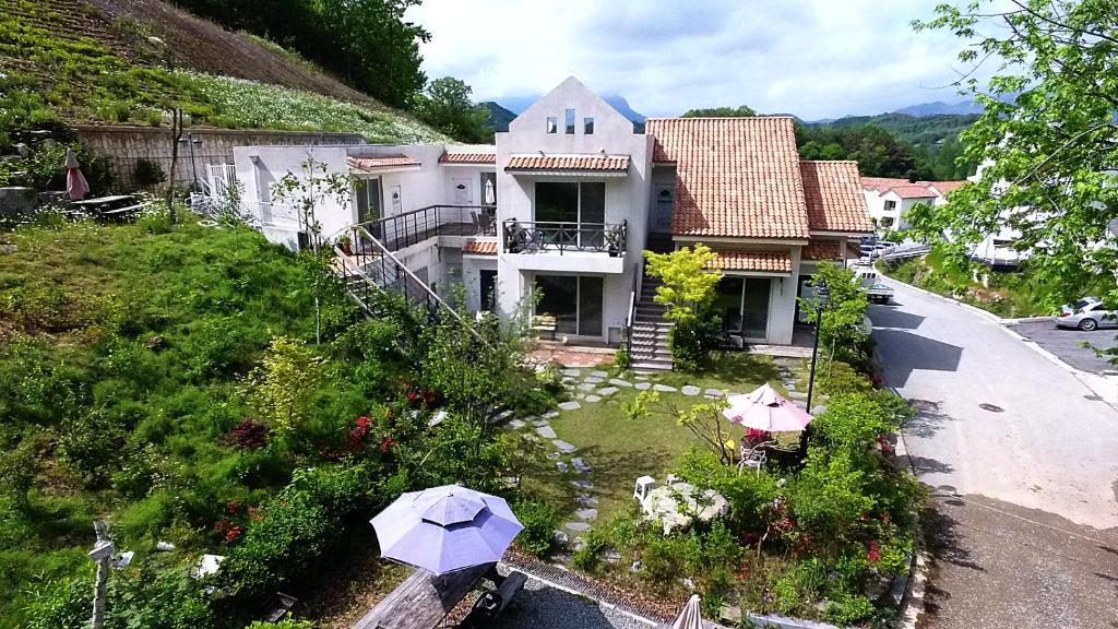 an aerial view of a house with umbrellas in a yard at Saint Paul De Vence in Damyang