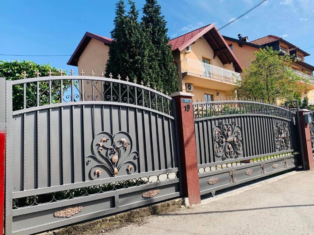 a black fence in front of a house at Villa AMANI in Sarajevo