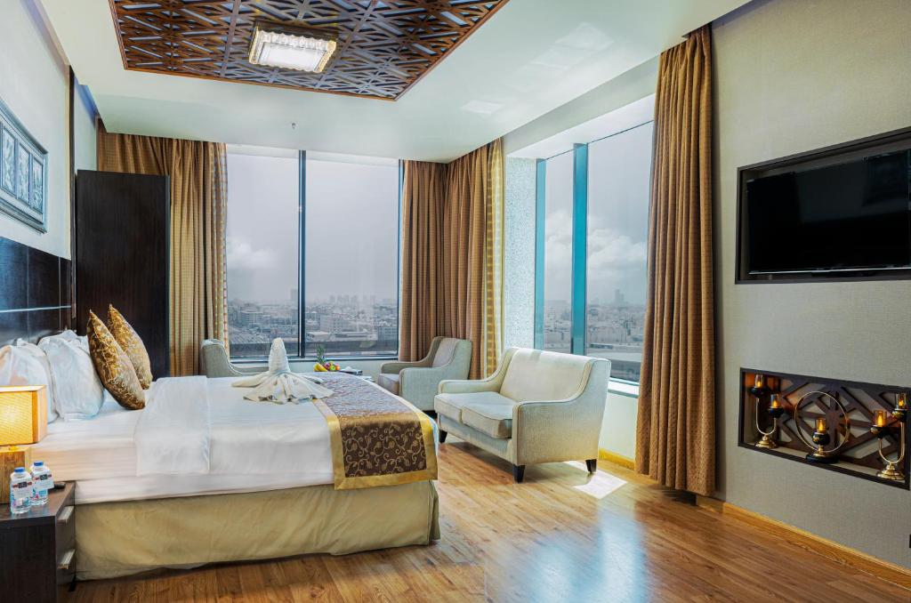 a hotel room with a bed and a large window at Platinum Seventy in Jeddah