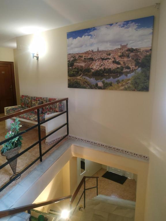 a view of a staircase with a painting on the wall at Hostal El Rincón - Casa Marcos in Yepes