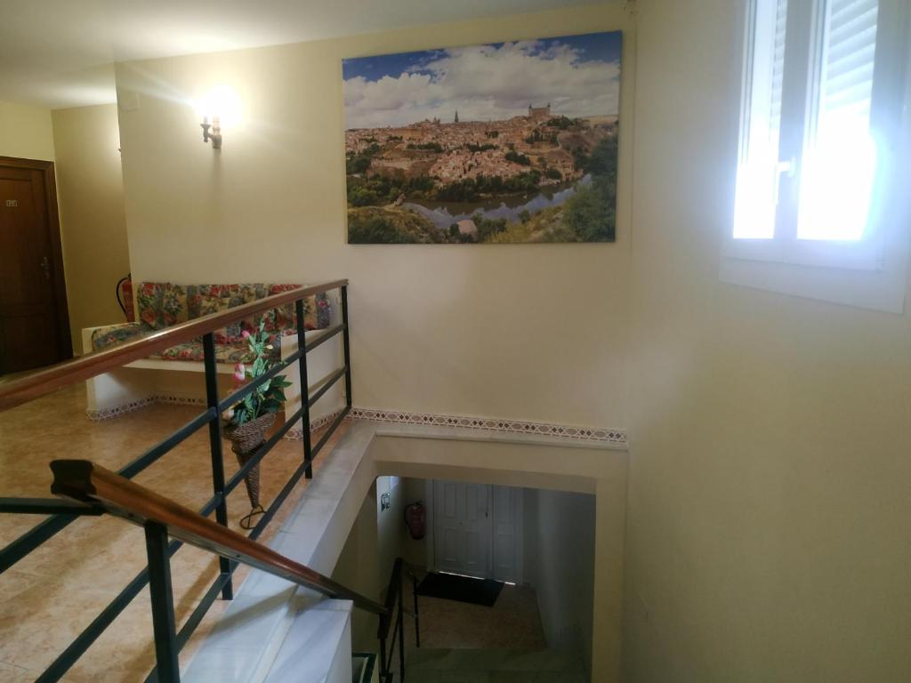 a room with a staircase with a painting on the wall at Hostal El Rincón - Casa Marcos in Yepes