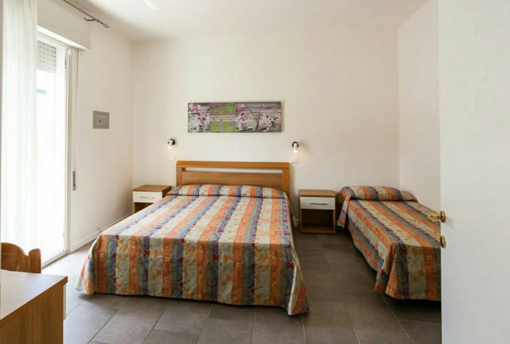 Postel nebo postele na pokoji v ubytování Hotel Augusta
