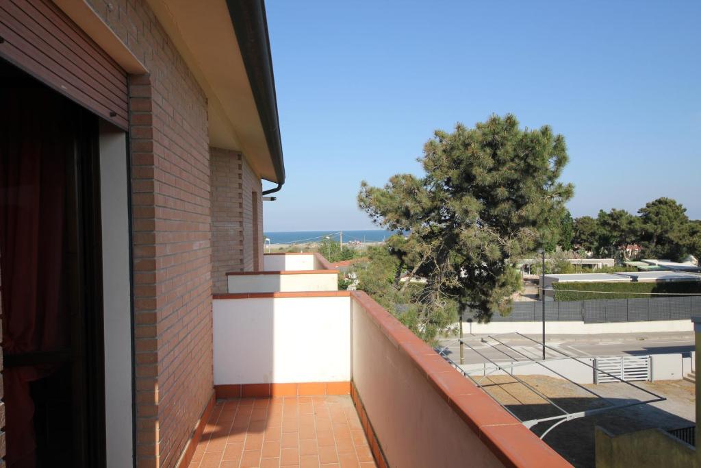 a balcony of a building with a view of a park at Villa Gloria appartamento E01 in Rosolina Mare