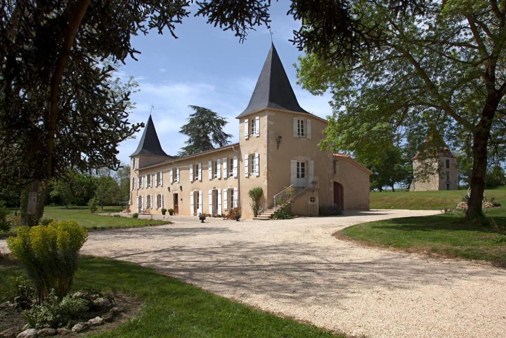 a large building with two towers on top of it at Maison d'hôtes de Charme Les Bruhasses in Condom
