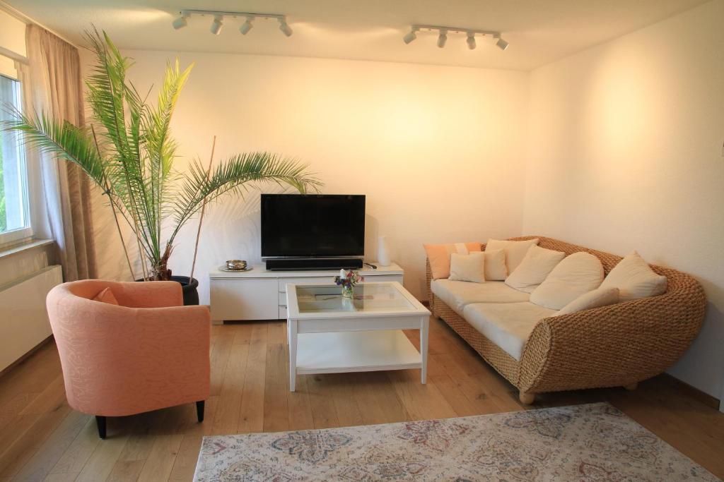 a living room with a couch and a tv at Comfort Lodging Stueckenfeld in Hannover