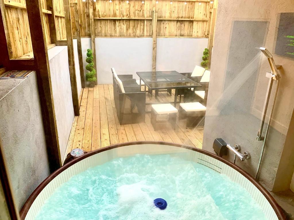 a jacuzzi tub in the middle of a patio at Victory luxury hot tub house in Blackpool