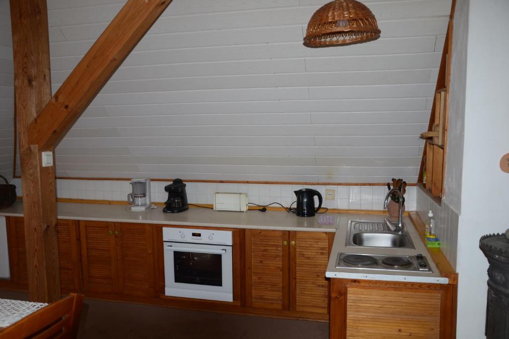 a small kitchen with a sink and a stove at Gyöngy Villa in Fonyód