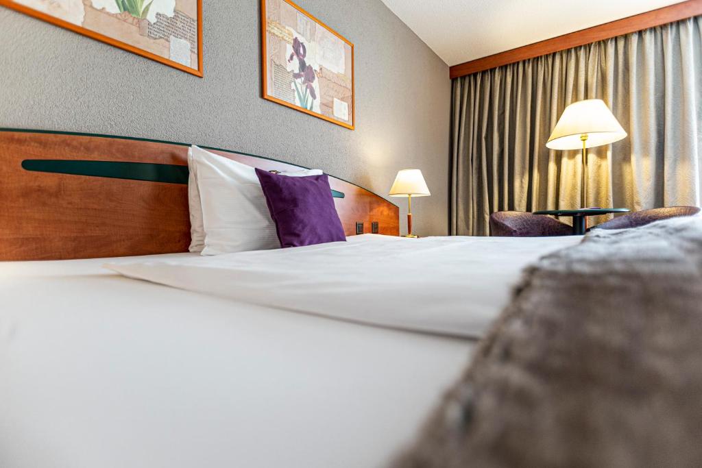 Postel nebo postele na pokoji v ubytování Hotel Münchwilen