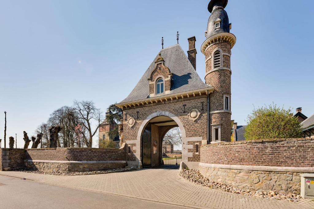 a small church with a tower and a gate at Poortgebouw Kasteel Borgharen - Maastricht in Maastricht