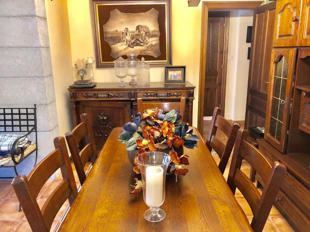 a table with a candle and a vase of flowers on it at Gran Pedroso de Llanes in Llanes