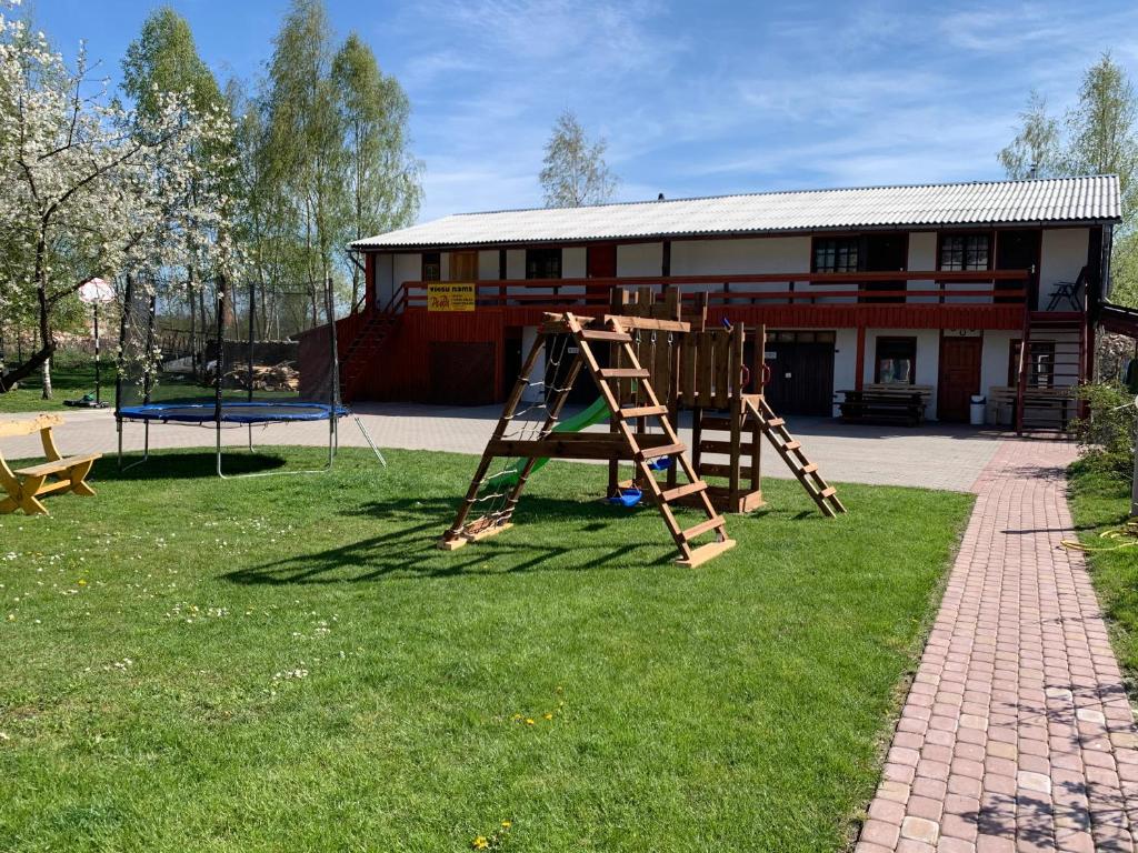 a playground in front of a building at Viesu nams Pupa in Kuldīga