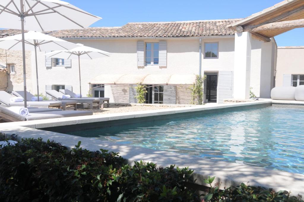 a swimming pool in front of a house at Villa Vagabonde in Gordes