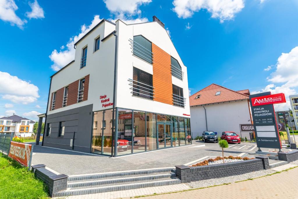 a building with an orange and white facade at NoclegiJarocin Bed & Breakfast in Jarocin