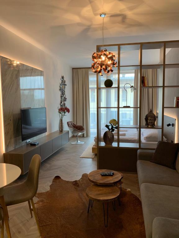 a living room with a couch and a table at Hrebienok 2 Apartman D109 in Smokovce