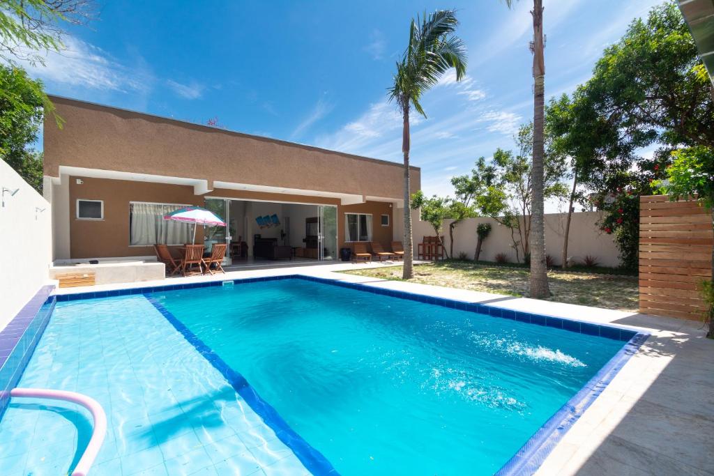 a swimming pool in front of a house at CASA FRANK COM PISCINA EM MARISCAL in Bombinhas