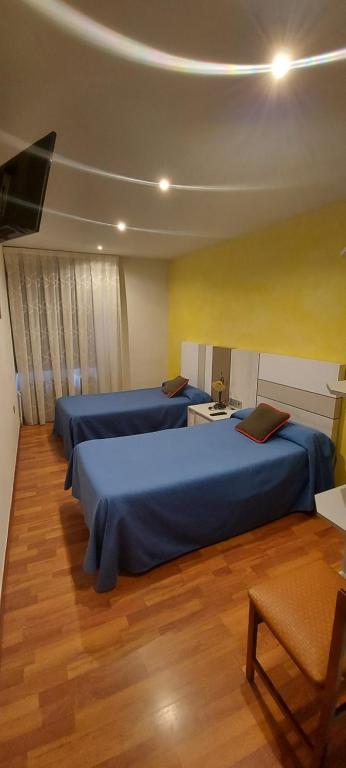 Postel nebo postele na pokoji v ubytování Hostal del campo