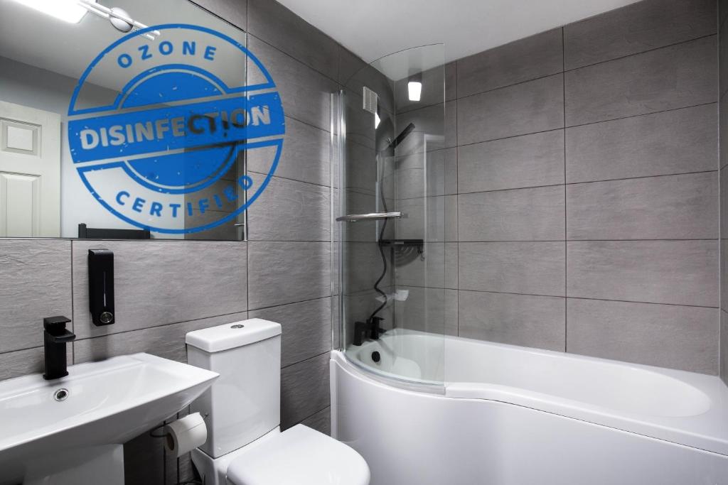 a bathroom with a white toilet and a sink at Holyrood Skyline Apartment in Edinburgh