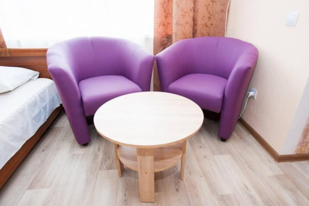 two purple chairs and a table in a room at Квартира по ул. Смілянська, 2 (2-й этаж) in Cherkasy