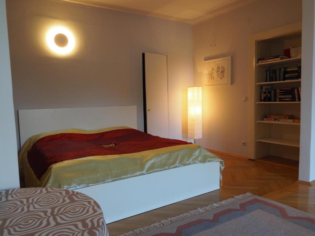 a bedroom with a bed with a light on it at Rizzi Haus in Klagenfurt