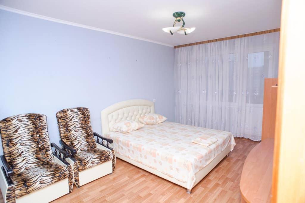 a bedroom with a bed and a pair of boots at ул. Героев Днепра 5, рядом Днепр in Cherkasy