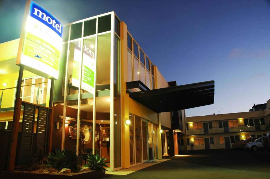 a building with a sign on the side of it at Harbour City Motor Inn & Conference in Tauranga